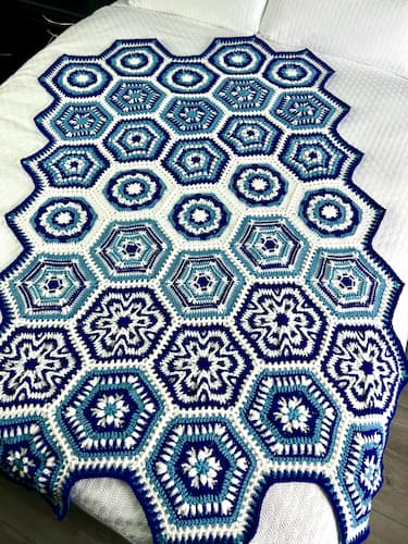 hexagon winter crochet blanket on the bed